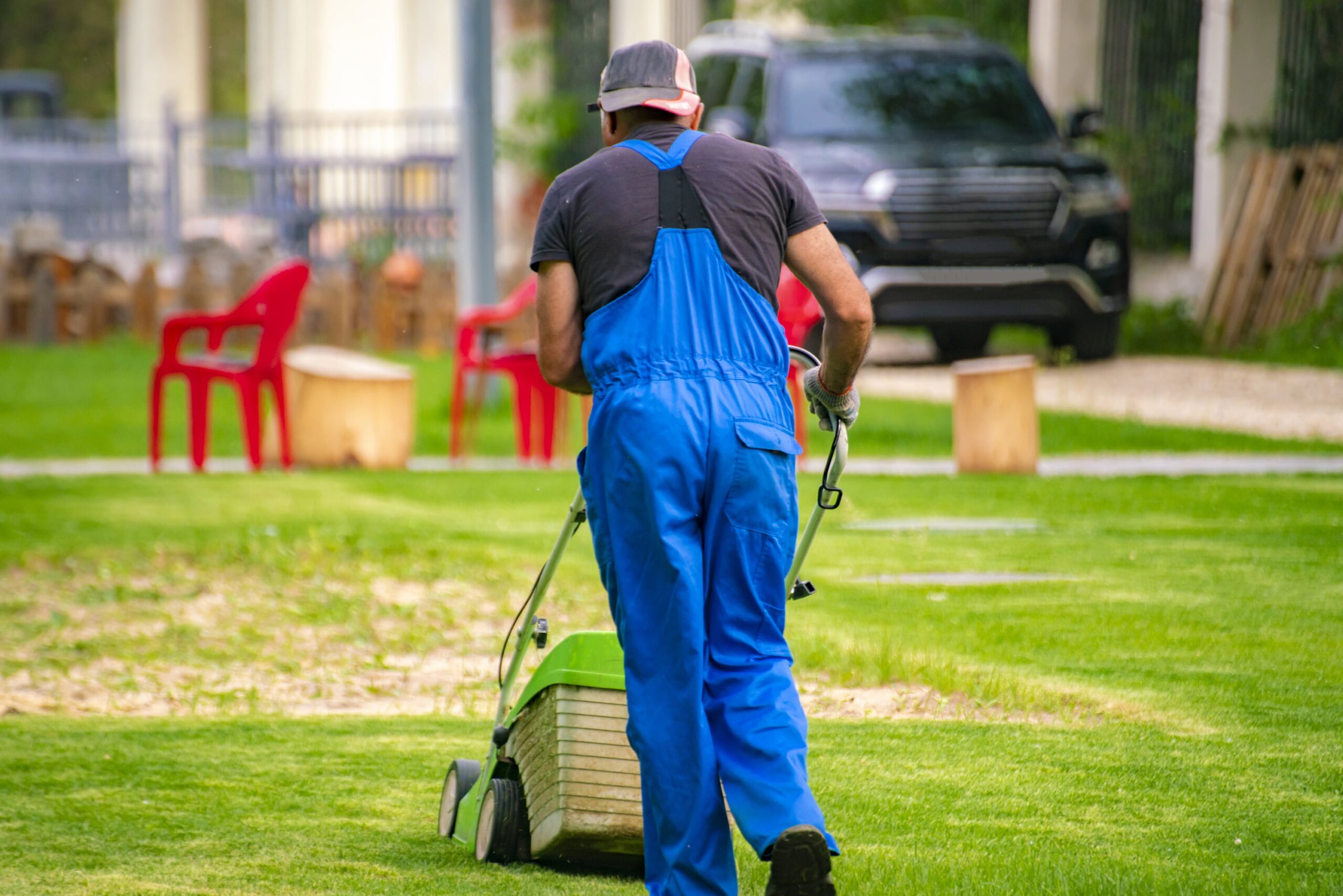 gardener worker cutting grass with mower in the ba 2025 01 27 02 34 53 utc min scaled