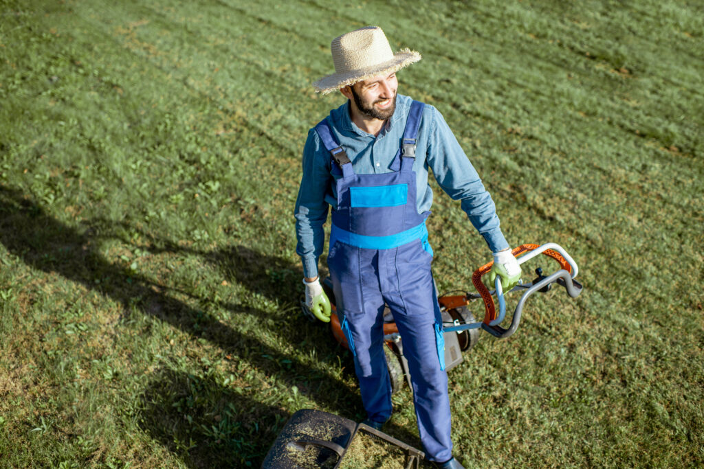 gardener working with lawn mower on the backyard 2025 03 15 14 17 37 utc scaled