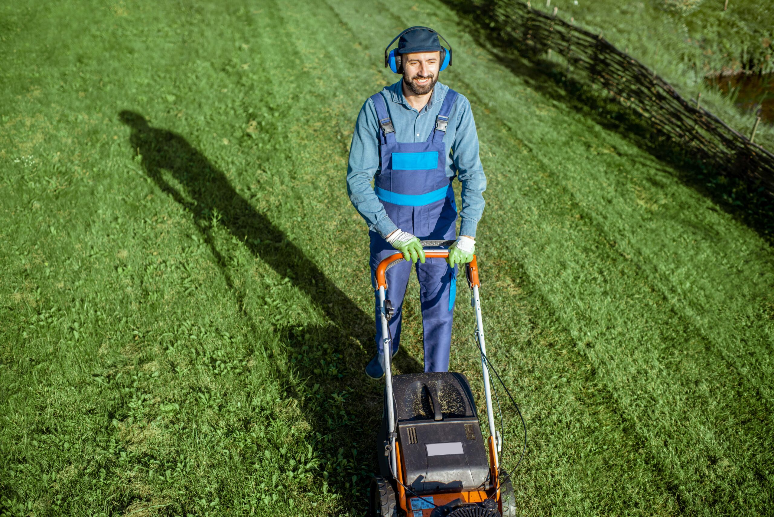 gardener working with lawn mower on the backyard 2025 03 16 09 40 17 utc min scaled